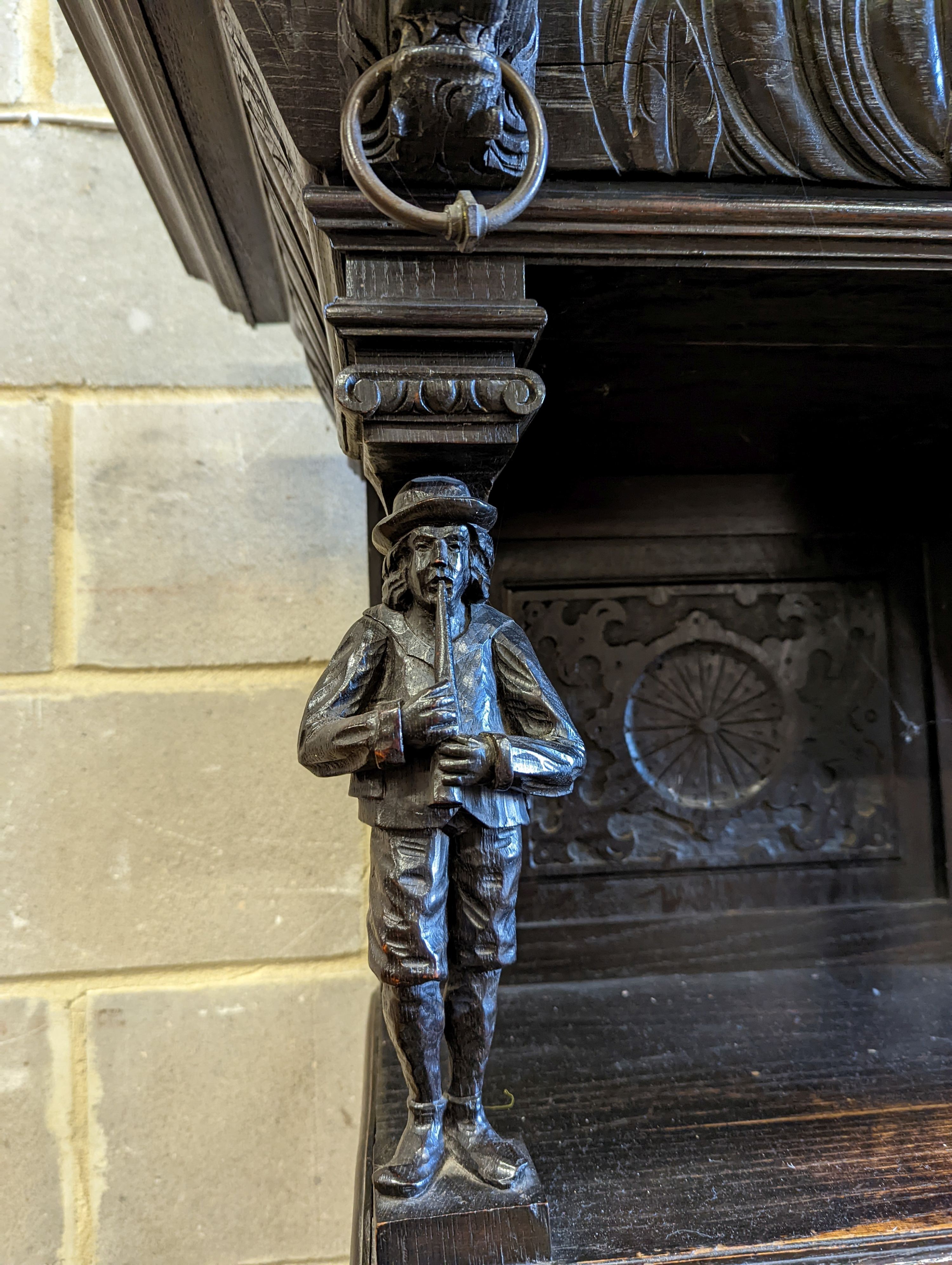 An early 20th century carved oak court cupboard in the Flemish style, length 200cm, depth 58cm, height 212cm